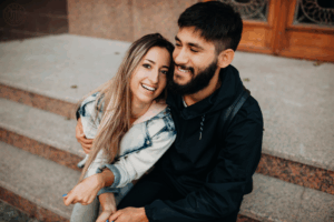 Couple hugging and laughing sharing a good time