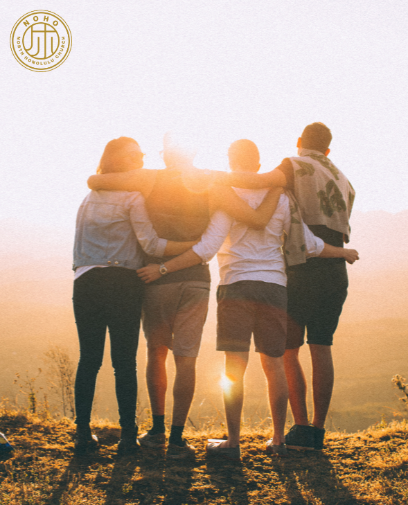 Four friends standing arm in arm at sunset, overlooking a scenic landscape, symbolizing friendship, unity, and shared moments